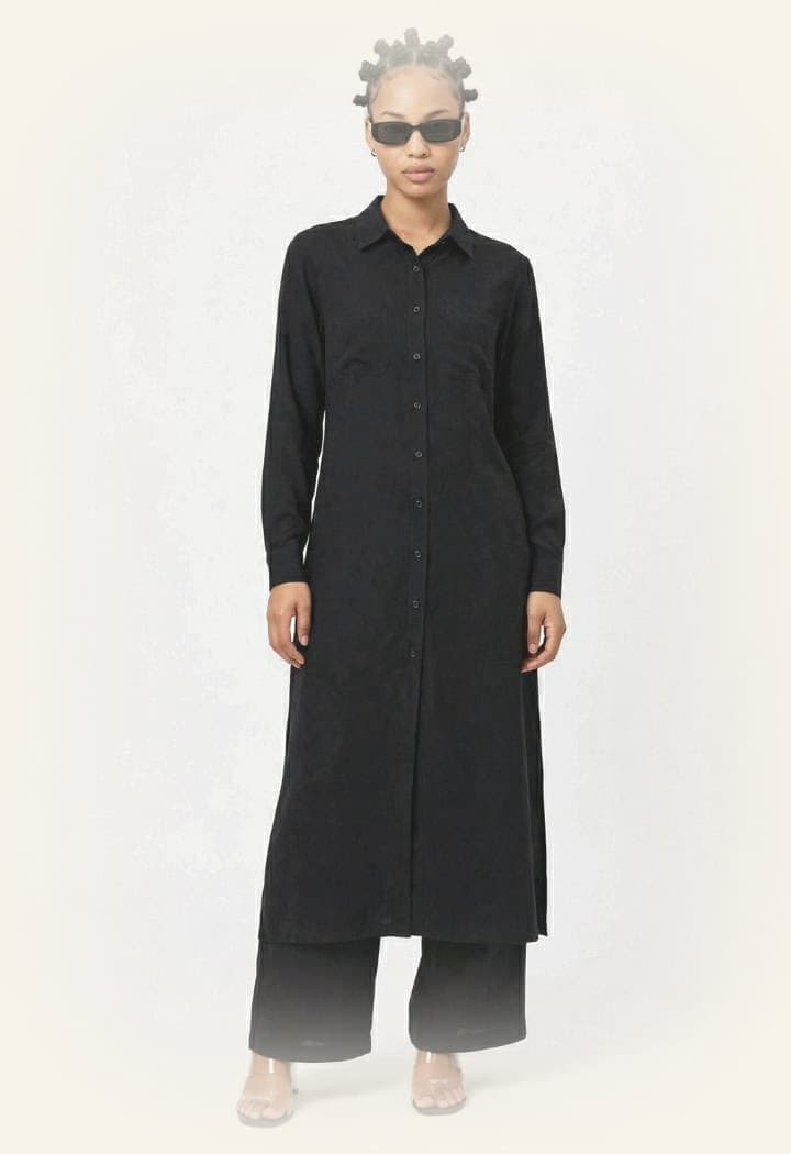 Model wearing the LJ long black button-up shirt dress with matching wide-leg trousers