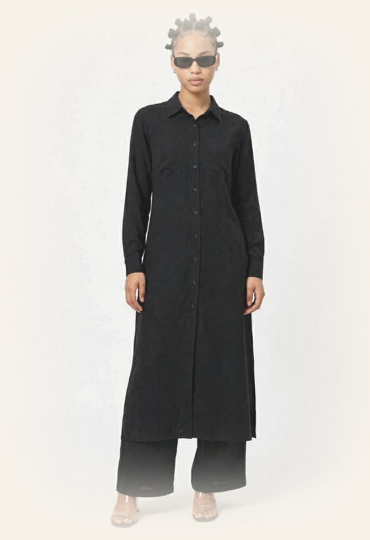 Model wearing the LJ long black button-up shirt dress with matching wide-leg trousers