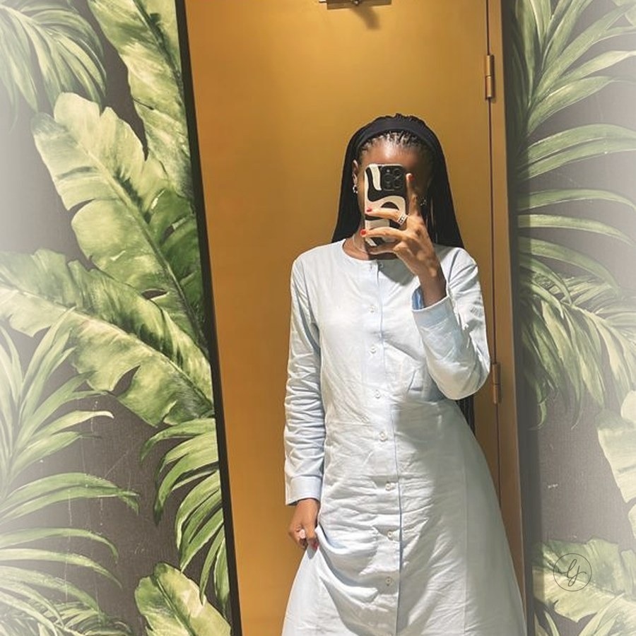 Model in powder blue kaftan with white wide-leg trousers