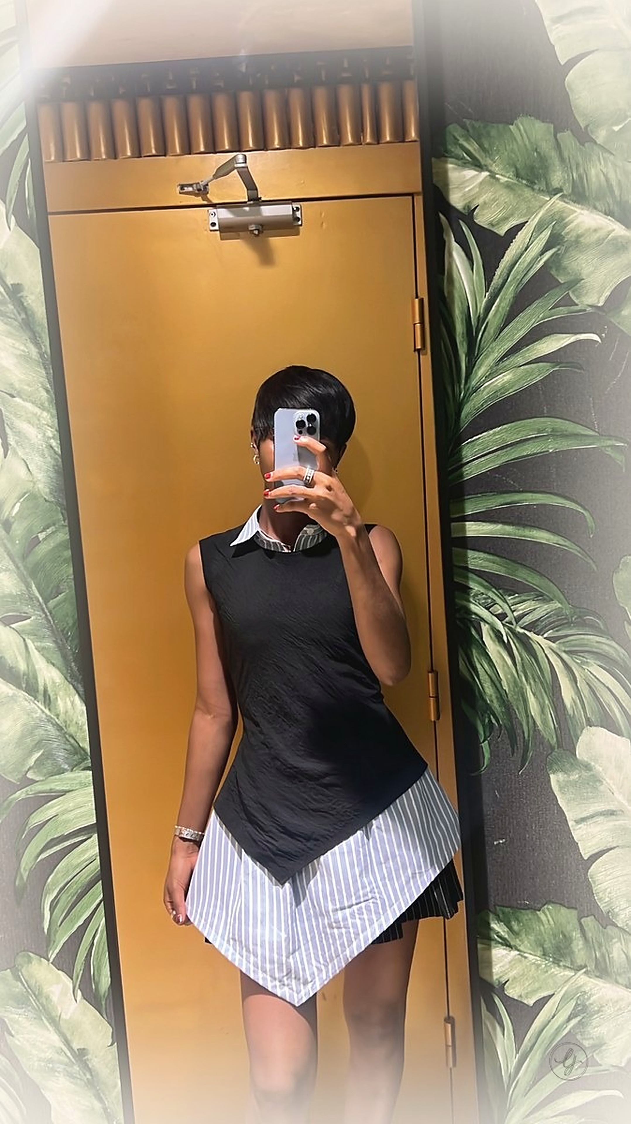 LJ look - black textured top layered over white shirt with asymmetrical striped skirt